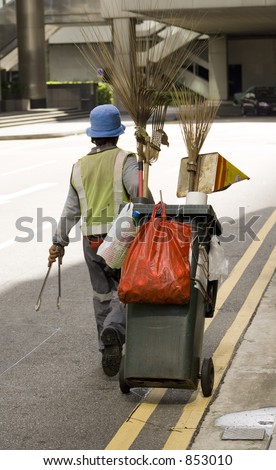 A street cleaner pulls his cart in the streets of Singapore