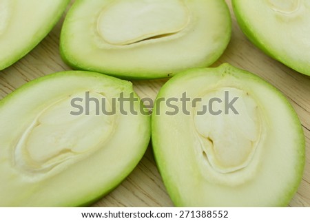 Sour mango and Mango seed slices on a wooden board, Mangifera indica L. Var.