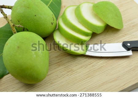 Sour mango slices on a wooden board,Mangifera indica L. Var.