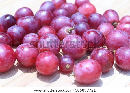 Purple grapes on brown background air density