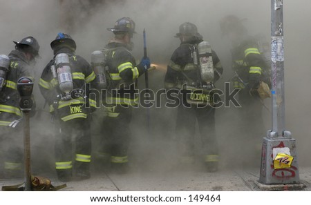 Bronx firefighters engulfed in smoke prepare to enter burning store