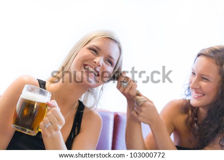 Two girls fighting over beer in restaurant