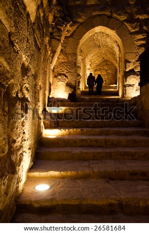 Two people walking up the stairs in the Ajlun Castle, Jordan.
