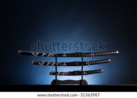 Three ancient japanese swords with a calm lighting. Text can be inserted in the upper part of the image.