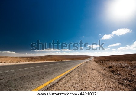 Road without cars in Jordan desert with sunny weather.