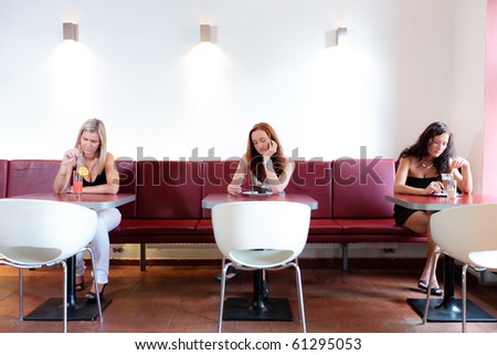 Three lone women sitting in restaurant thinking