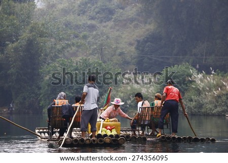 YANGSHUO, GUILIN, CHINA - OCTOBER 15,2014: Visitors buying cool drinks at one of the pit stops of 1.5 hours ride along Yulong river bamboo rafting.