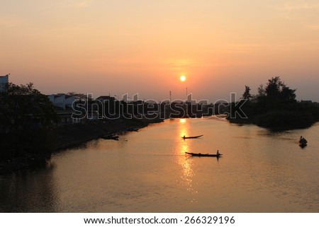 The peaceful and quit life of people on the river in the sunset
