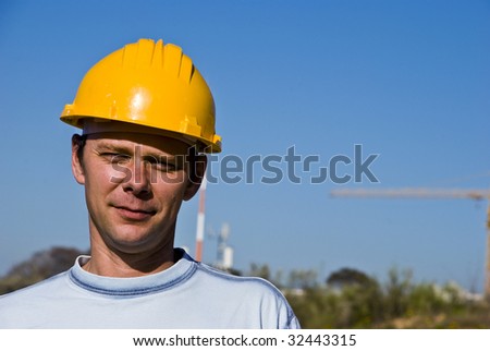 Construction engineer in the yellow helmet standing alone.