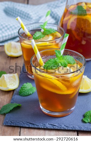 Refreshing homemade lemon iced tea on a black slate tray