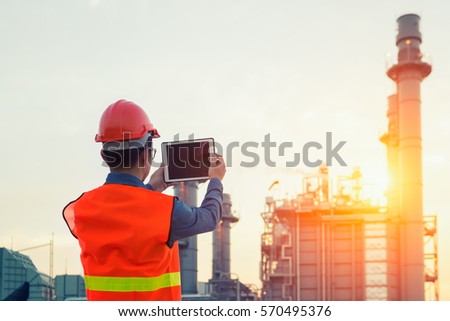 Engineer working with tablet PC near power plant