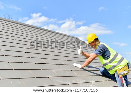 Builder Working On Roof Of New Building