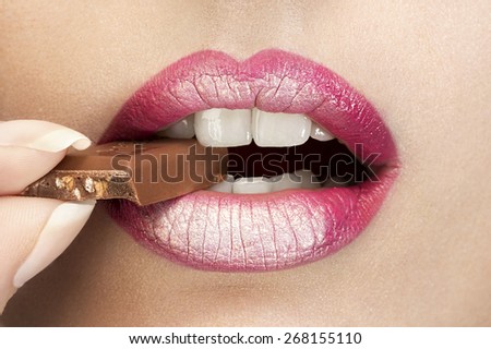 girl eating a piece of chocolate