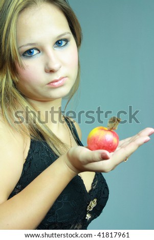 beautiful young girl keeps on palm apple