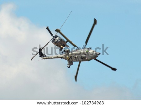 SOUTHPORT, ENGLAND - JULY 23: Two Royal Navy Black Cats Lynx helicopters perform aerobatics and mid air stunts on July 23, 2011 in Southport, England.
