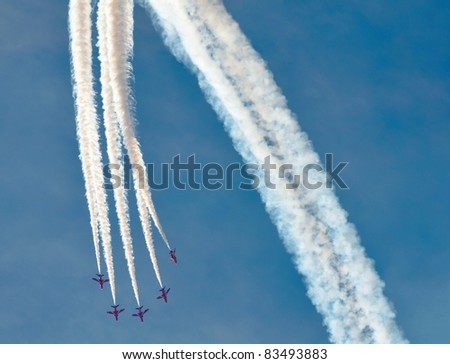 SOUTHPORT, ENGLAND - JULY 23: Hawk T Red Arrow jets from the British Air Force perform aerobatics and mid air stunts on  July 23, 2011 in Southport, England.