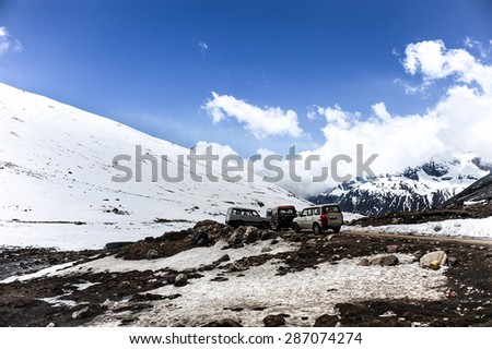 Cars parking among snow mountains at Zero point ,Sikkim,Northern India.