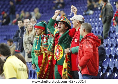 PORTO, PORTUGAL - OCTOBER 8: Portuguese supporters enjoying  the Euro 2012 Group Stage Qualifying match against Denmark on October 8, 2010 in Porto, Portugal