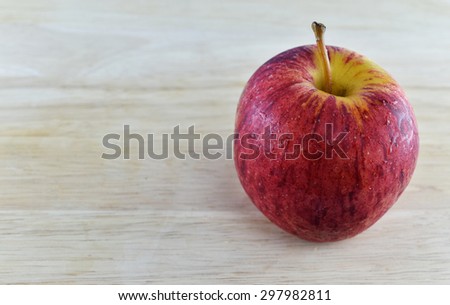 Red apple on wooden for healthy diet and body weight control.
