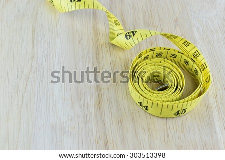 yellow measuring tape concept for healthy diet and body weight control.
