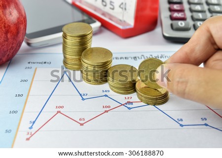 Hand, pen, apple, money,clock, telephone and calculator placed on document., concept for business