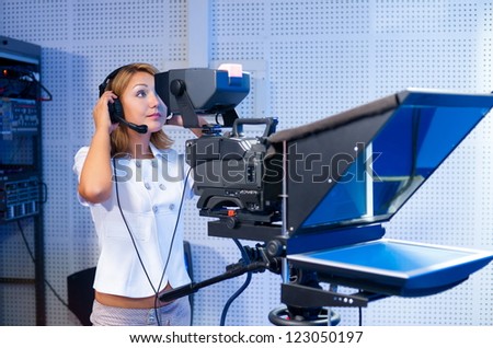 a woman cameraman at a TV studio during live broadcasting