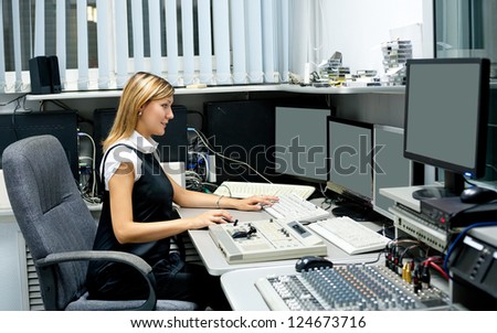 TV director (young woman) at editor in studio