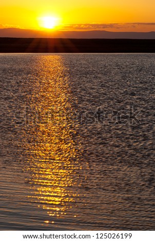 Baikal sunset - sun goes down over water