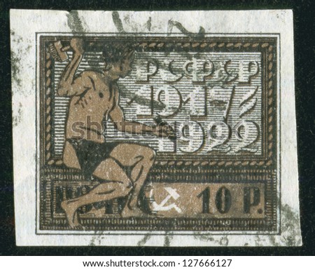 SOVIET UNION - CIRCA 1922: A stamp printed by the Soviet Union Post shows a worker, circa 1922