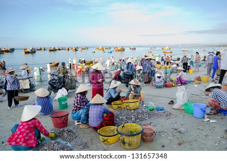 MUI NE, VIETNAM - FEBR 27: Mui Ne is a popular tourist attraction in Vietnam. A lot of fishers sort out their catch on the shore and sell fish to dealers, Feb 27, 2013, Mui Ne, Phan Thiet, Vietnam.