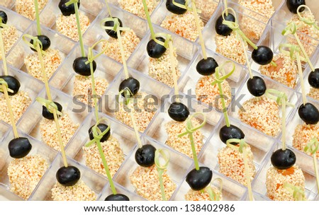 a lot of salmon pieces with sesame seed in small boxes on buffet table, catering