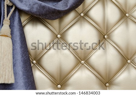 golden upholstery, blue curtain with support and tassel