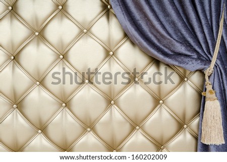 golden upholstery, blue curtain with support and tassel