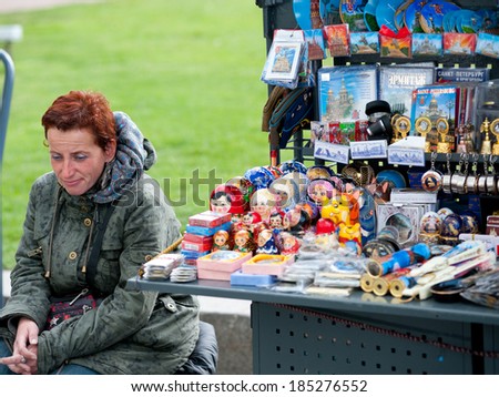 ST. PETERSBURG - MAY 29, 2011: An unidentified woman sells souvenirs, mainly Russian dolls, street stand near St. Isaacs Cathedral. The city was the 10th most popular European tourist city in 2012.