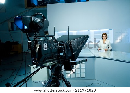 young television announcer at studio during live broadcasting