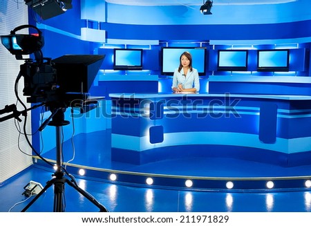 television announcer at studio during live broadcasting