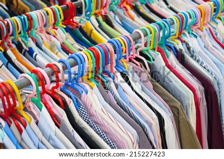 a lot of mens or ladies shirts on hangers
