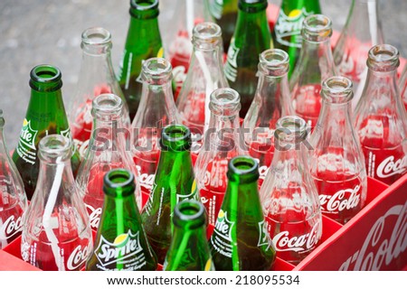 HO CHI MINH, VIETNAM - JULY 7, 2014: Empty bottles of Coca Cola and Sprite in a plastic box. Based on Interbrands best global brand study of 2011, Coca-Cola was the worlds most valuable brand.