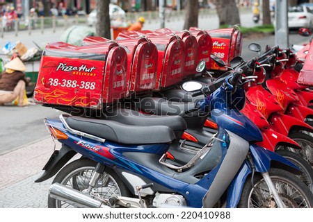 HO CHI MINH, VIETNAM - JULY 6, 2014: A row of Pizza Hut delivery motorcycles in the downtown. Pizza Hut, Inc. is a subsidiary of Yum! Brands, Inc., the worlds largest restaurant company.