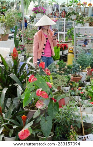 DALAT, VIETNAM - JULY 24, 2014: An unidentified woman sells flowers and plants in the Flower Park, one of major tourist attractions in the city.