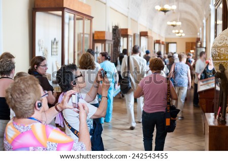 ST. PETERSBURG - JUNE 30, 2011: A group of unidentified tourists have a guided tour in the Hermitage, the biggest in Russia. To see all the displays one should walk 20 kilometers.
