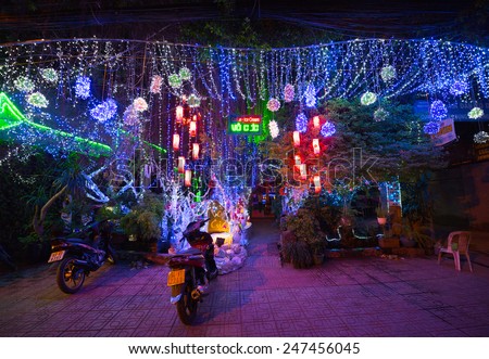 HO CHI MINH, VIETNAM - DECEMBER 28, 2014: A coffee bar decorated with illumination curtains for Christmas. It is the time when the high tourist season begins.