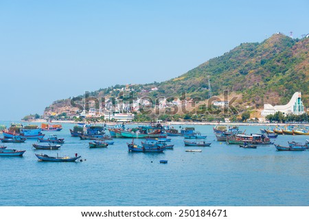 VUNGTAU, VIETNAM - JANUARY 15, 2015: Several ships and boats are at an anchor and move at the city port. The city is popular among Saigon people as sea resort.