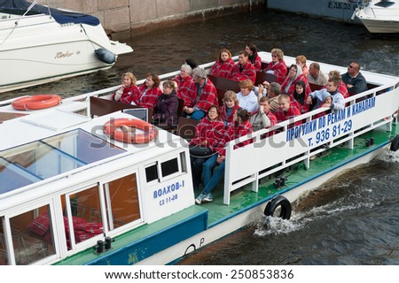 ST. PETERSBURG - MAY 29, 2011: Unidentified tourists move by a river excursion bus on the Neva river. The city was the 10th most popular European tourist city in 2012.