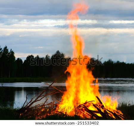 a big fire at a lake shore on Midsummer Day, Finland