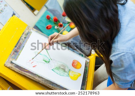 ULAN-UDE, RUSSIA - MAY 10, 2011: An unidentified girl paints at a drawing school of the City Palace of Childrens and Junior Arts, the biggest centre offering hobby circles and studies for children.