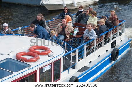 ST. PETERSBURG - MAY 29, 2011: Unidentified tourists move by a river excursion bus on the Neva river. The city was the 10th most popular European tourist city in 2012.