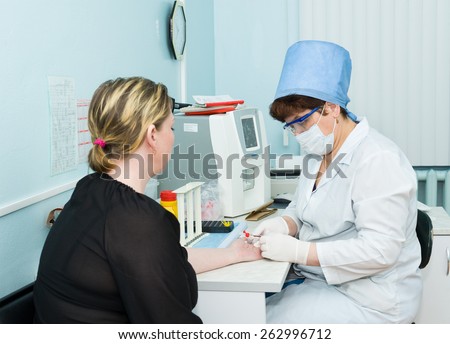 ULAN-UDE, RUSSIA - APRIL 6, 2010: An unidentified nurse makes blood test for volunteers before they donate blood.The City Blood Service makes a promo action for donorship popularization.