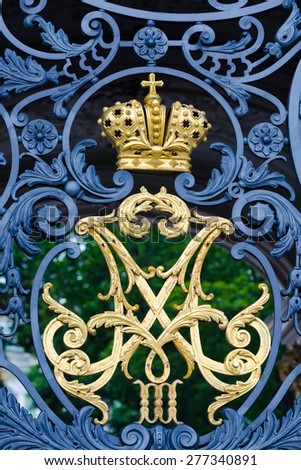 ST PETERSBURG - JUNE 30, 2011: A gilt Russian imperial monogram of Alexander III and Maria Feodorovna on the Hermitage front gate. Their son Nicholas II was the last Emperor of Russia.