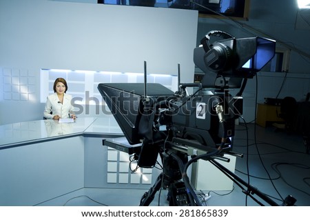 young television announcer at studio during live broadcasting